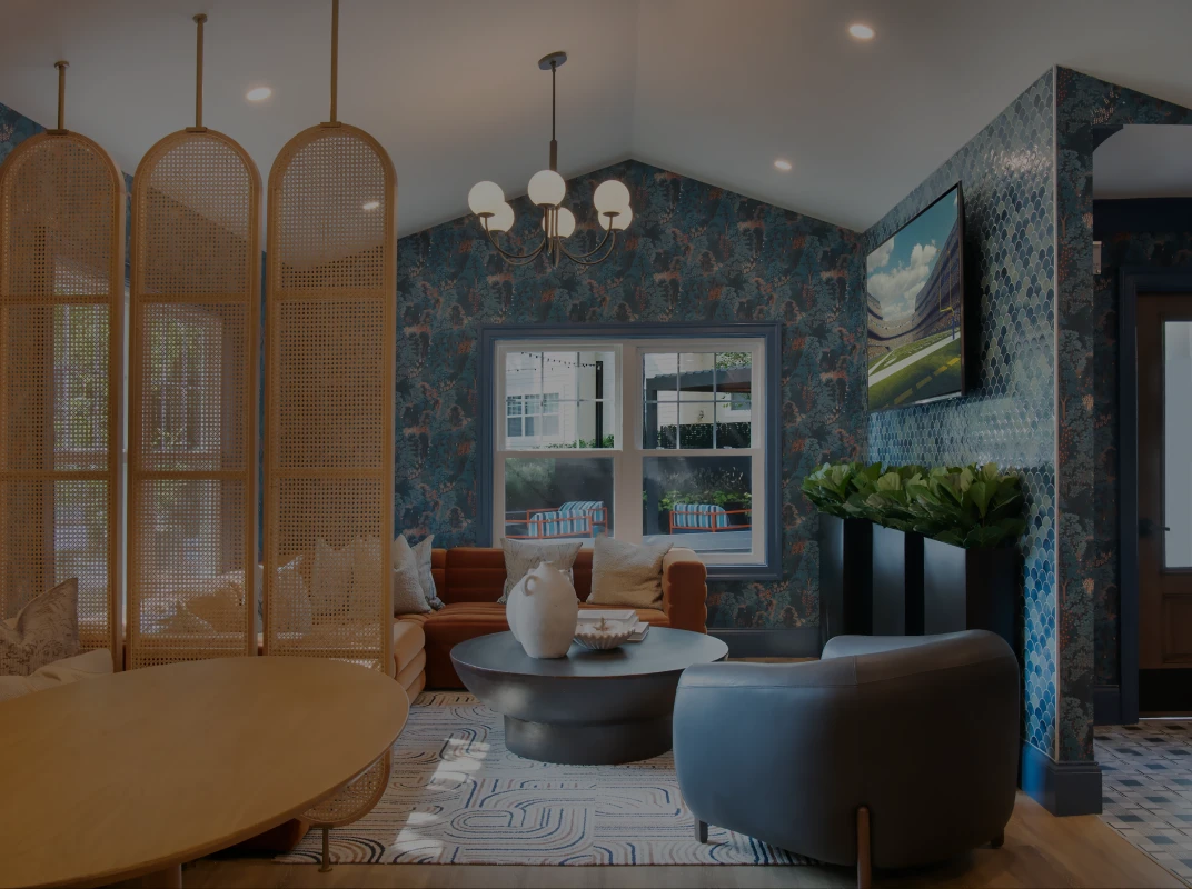 Three friends laugh around a grill on a summer afternoon