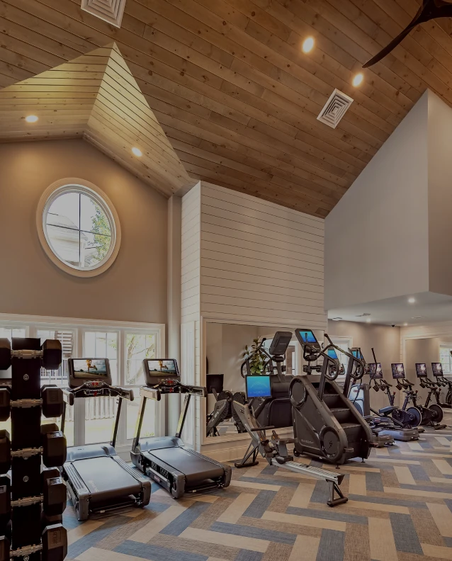 Three friends laugh around a grill on a summer afternoon
