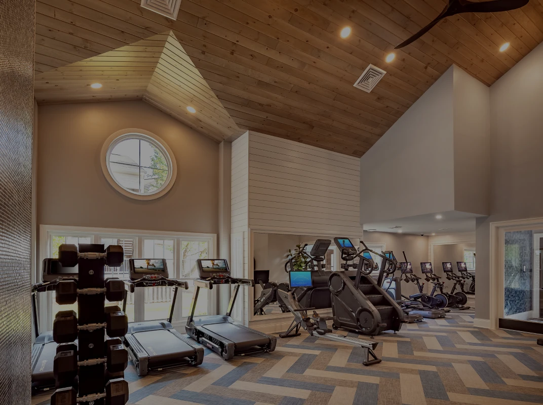 Three friends laugh around a grill on a summer afternoon
