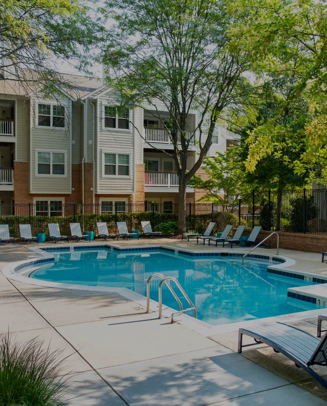 Three friends laugh around a grill on a summer afternoon