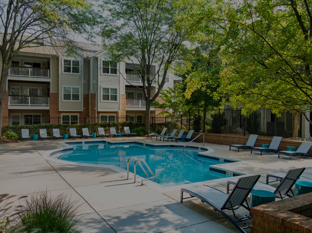 Three friends laugh around a grill on a summer afternoon