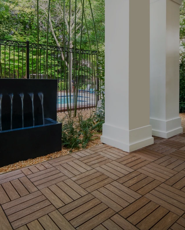 Three friends laugh around a grill on a summer afternoon